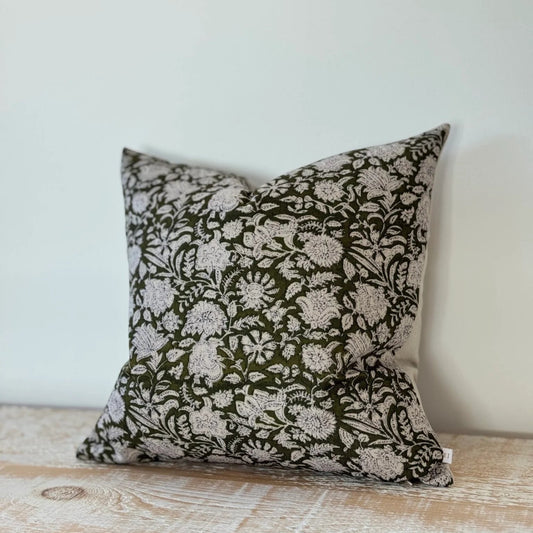 Decorative pillow with floral pattern on a wooden surface