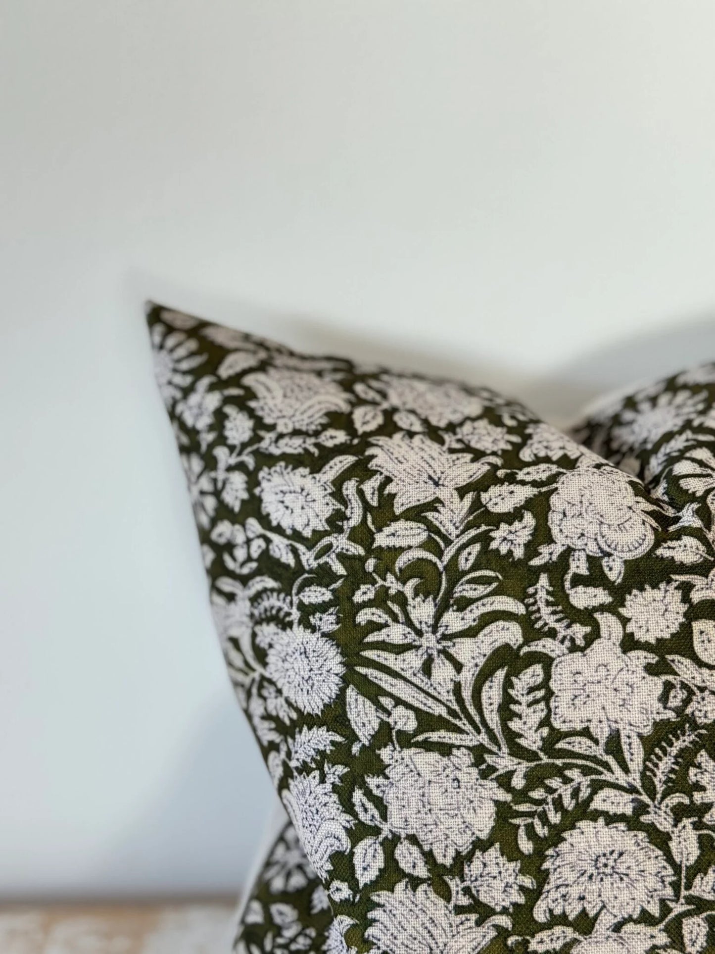 Floral patterned pillow on a neutral background