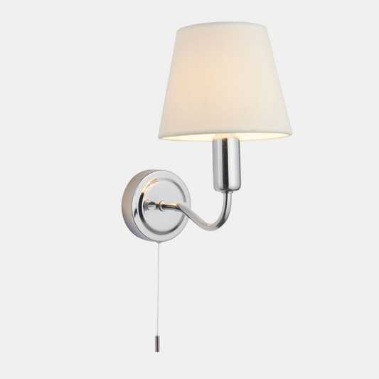 Wall-mounted lamp with a cream shade and chrome fixture on a white background
